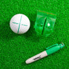 Golf ball with a sharpie and alignment tool on green grass